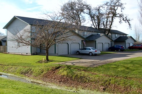 a white building with cars parked in front of it