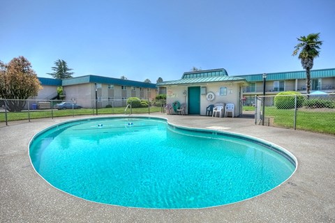 A large outdoor swimming pool with a fence around it.