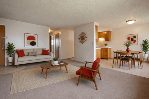 A living room with a couch, chair, and table.