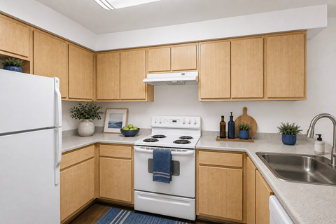 A kitchen with wooden cabinets and a white refrigerator.