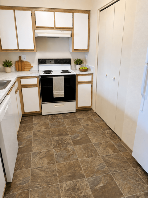 A kitchen with a black oven and white cabinets.