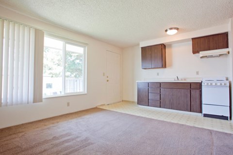 A kitchen area with a white stove and brown cabinets.