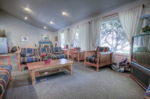 A living room with a sofa, armchairs, and a coffee table.