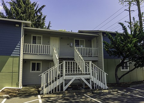 the front of a house with a ramp and a porch
