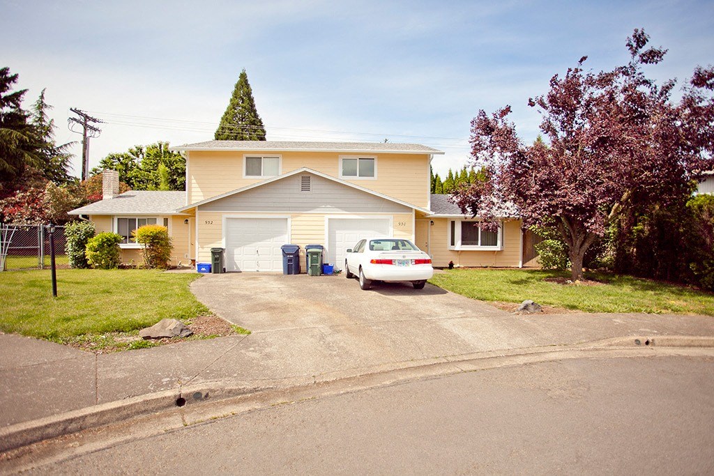a house with a white car parked in front of it