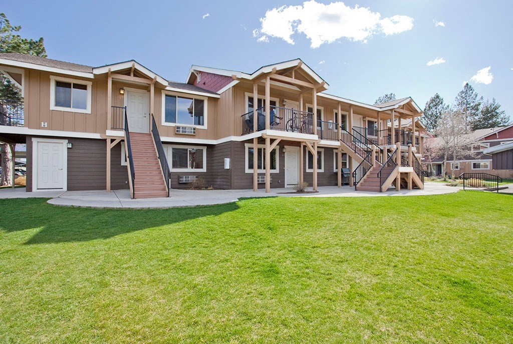 the back of a house with a yard and a staircase