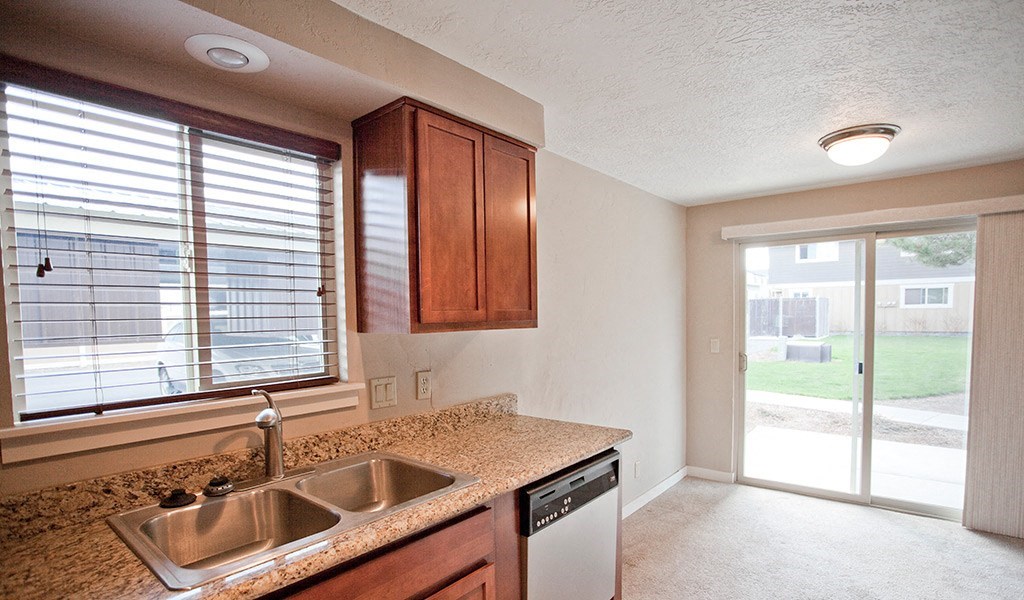 an empty kitchen with a sink and a window
