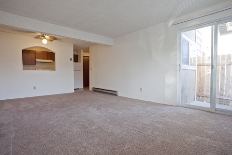 the living room of an empty apartment with a large window