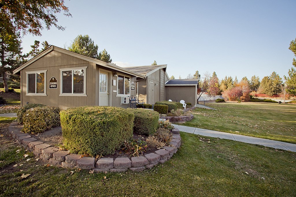 a house with a yard and a sidewalk in front of it