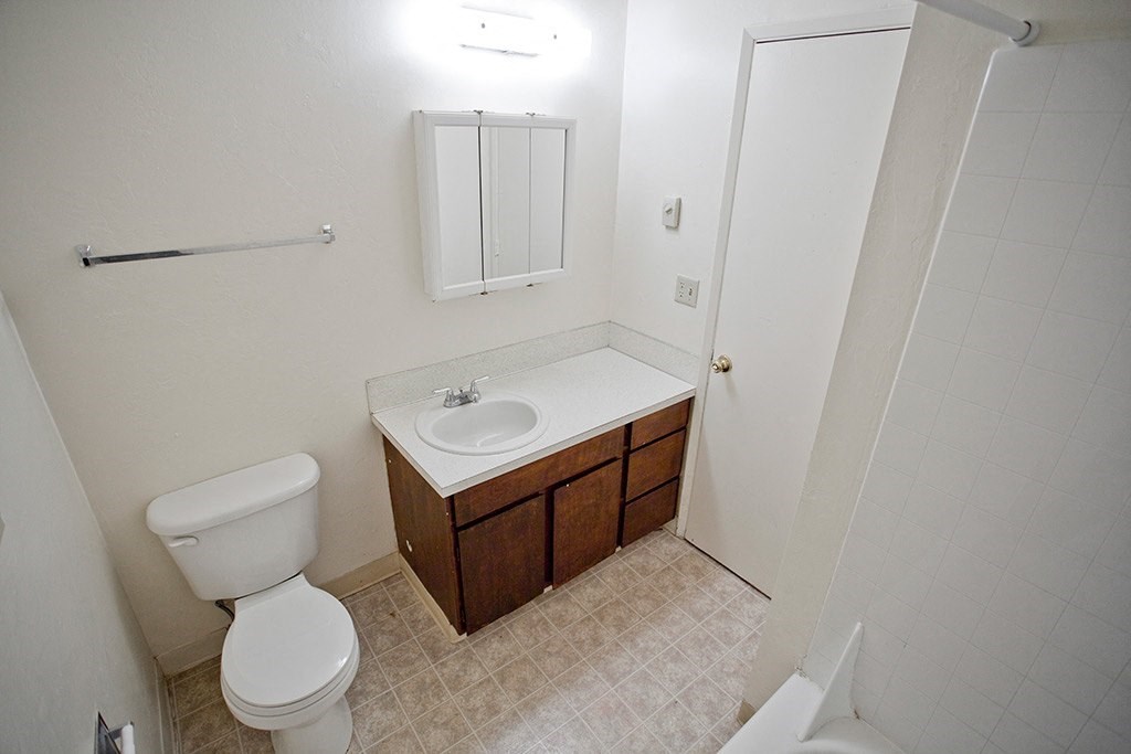 a bathroom with a toilet sink and a mirror