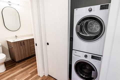 A white washing machine in a laundry room.
