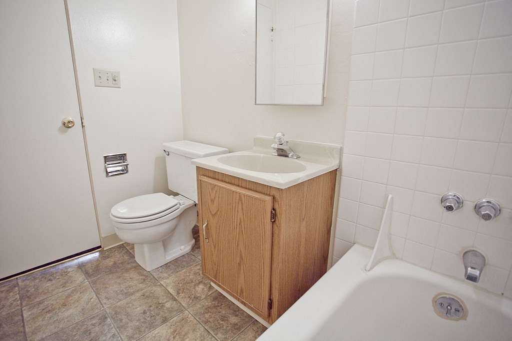 an empty bathroom with a toilet sink and bath tub