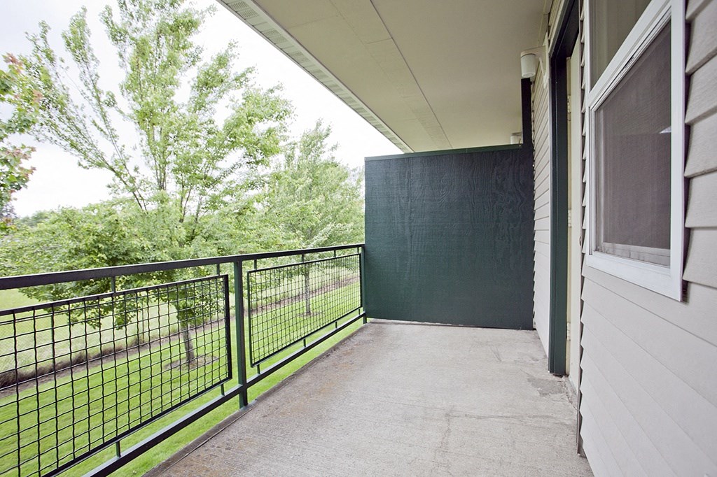 the view of the yard from the balcony of an apartment building