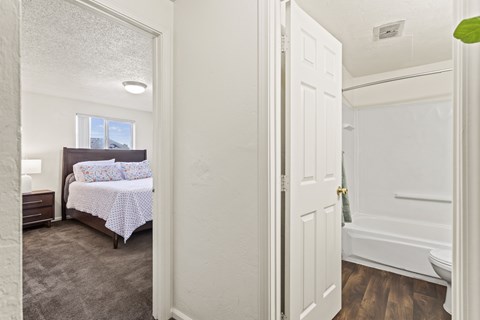 A bedroom with a bed and a window.