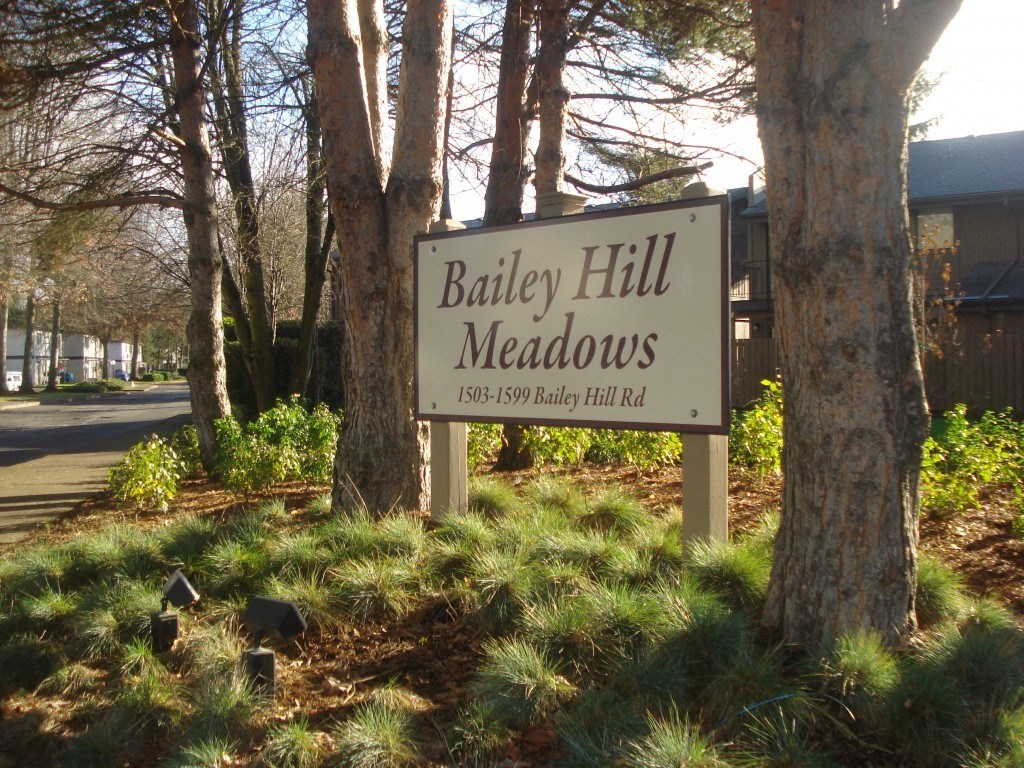 a sign in front of trees
