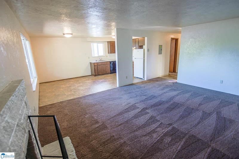 an empty living room and kitchen in a house