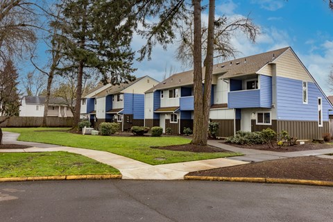A row of houses with blue siding and white trim.