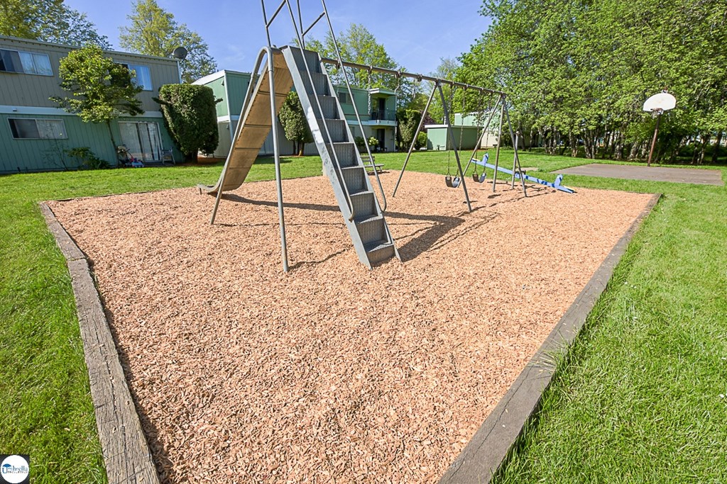 a swing set on a playground in a park