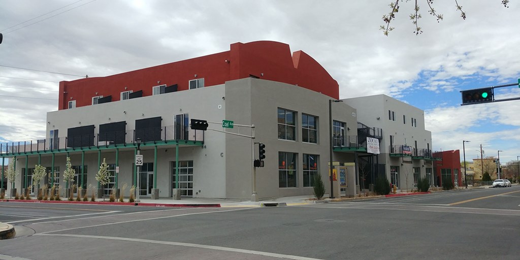 a red and white building on the corner of a street