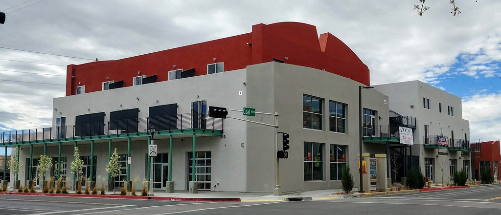 a red and white building on the corner of a street