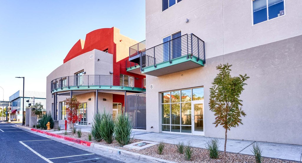 a building with two balconies and a street in front of it