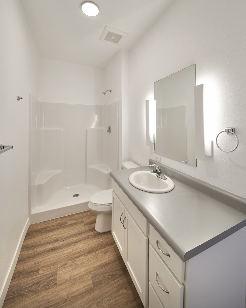 a bathroom with a sink and a toilet and a shower