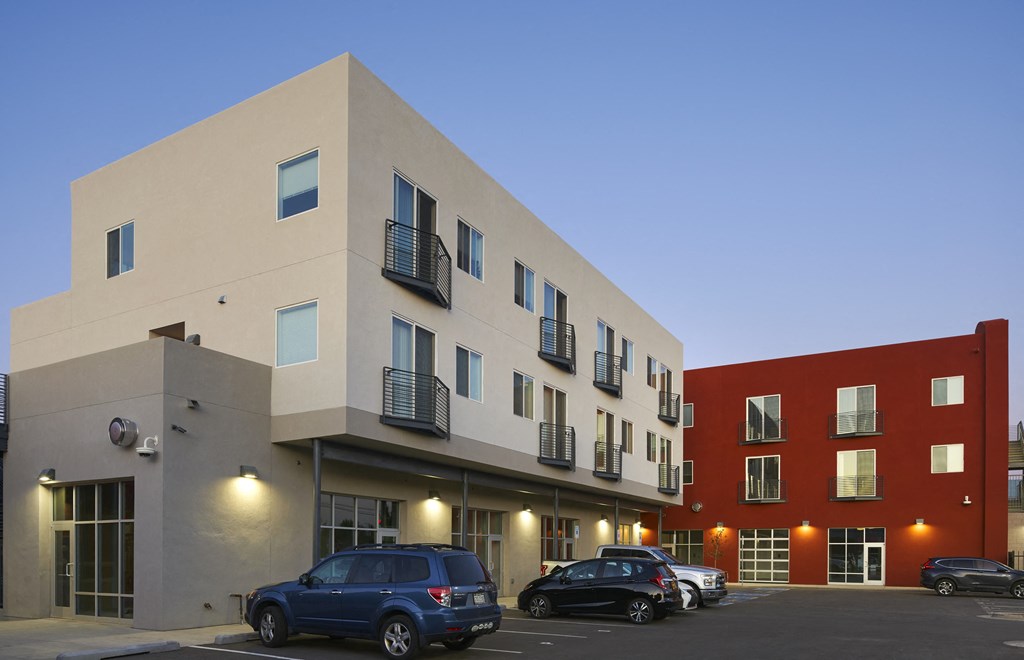 the facade of a building with cars parked in front of it