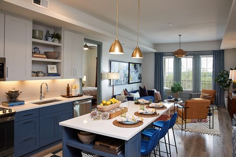 A kitchen with a dining table and chairs.