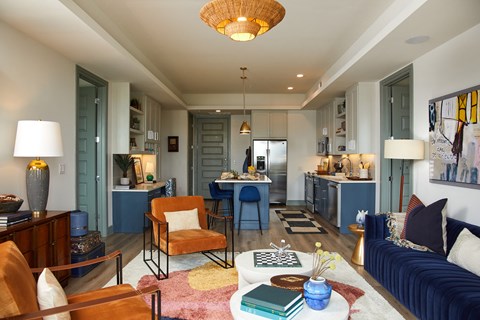 A living room with a blue couch and a yellow chair.