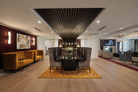 A modern living room with a wooden floor and a large dining table.
