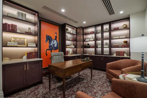 A room with a brown carpet and a wooden table.