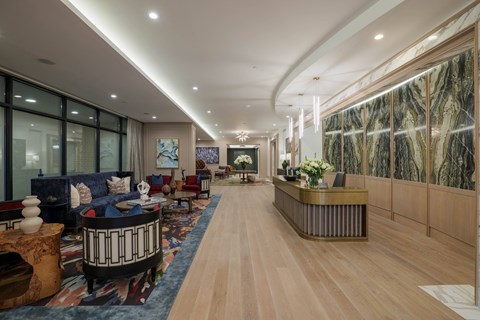 A long hallway with a reception desk at the end.