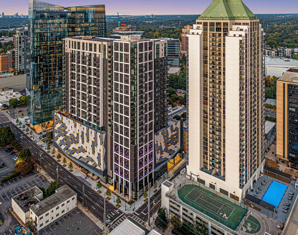 an aerial view of three tall buildings in a city