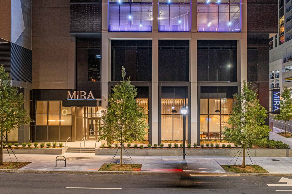 a night view of the front of the mira building