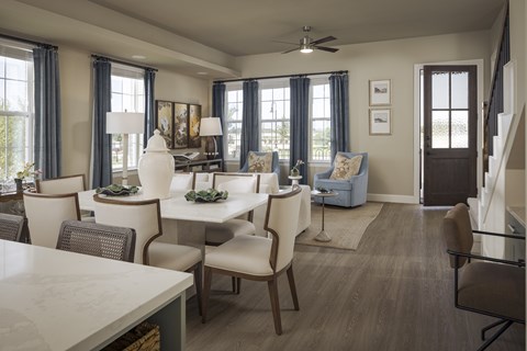 A well-lit dining room with a table set for six.