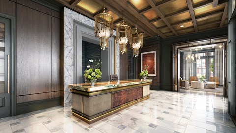 A reception area with a marble counter and chandelier.