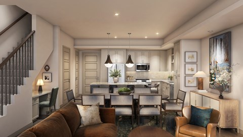 A modern living room with a brown couch and a kitchen in the background.