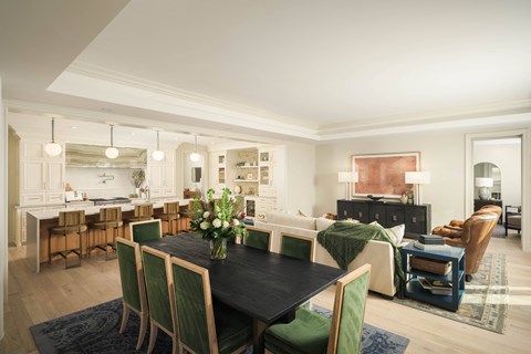 a living room and dining room with a table and chairs