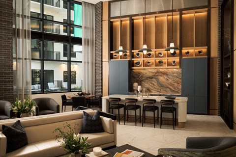 A modern living room with a large painting on the wall and a dining table set up.