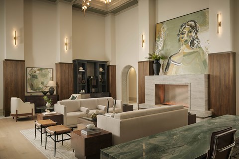 A living room with a fireplace and a painting on the wall.