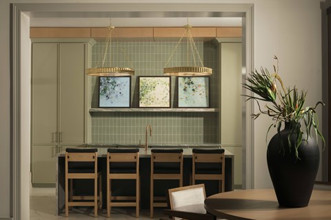 A dining room with a table, chairs, and a vase on it.