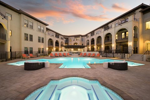 A large outdoor swimming pool surrounded by a building.