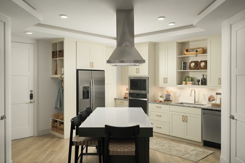 A modern kitchen with a table and chairs in the middle.