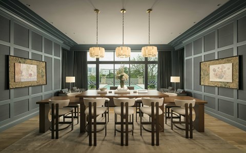 A dining room with a large table and chairs.
