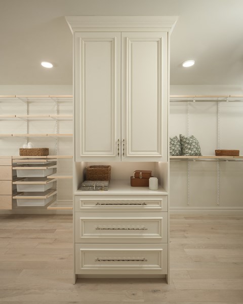 A white kitchen with a large cabinet and drawers.