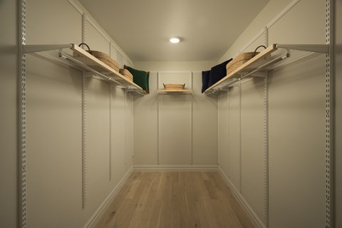 A long hallway with shelves on the side and baskets on the shelves.