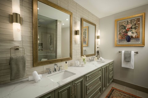 A bathroom with a large mirror and a sink.