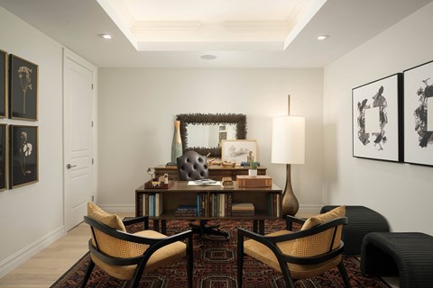 A living room with a sofa, armchairs, and a coffee table.