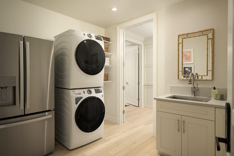 A modern laundry room with a washer and dryer stacked on top of each other.