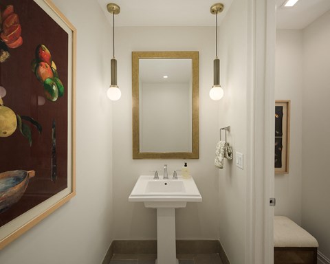 A bathroom with a white sink and a mirror.